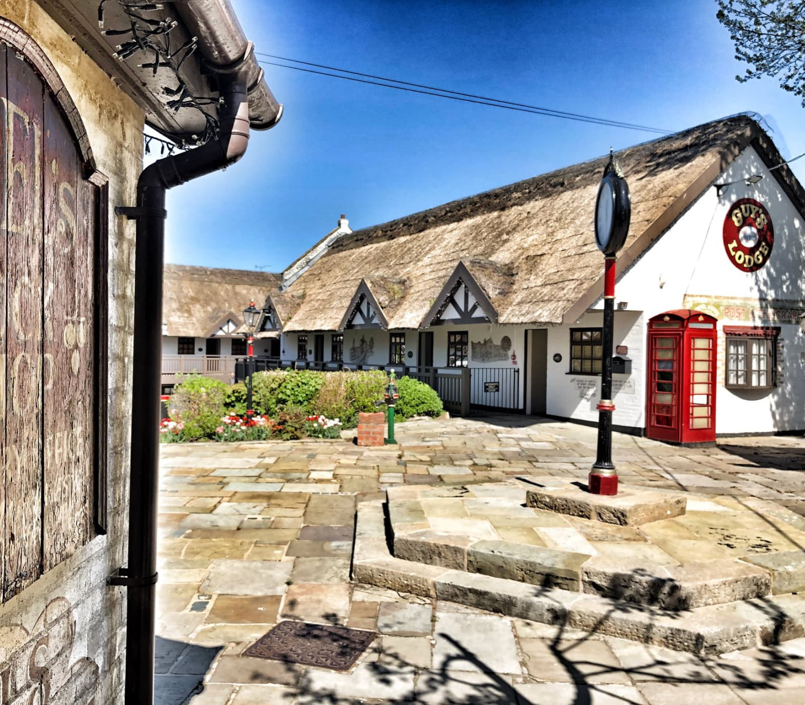 Thatched hotel with village clock 